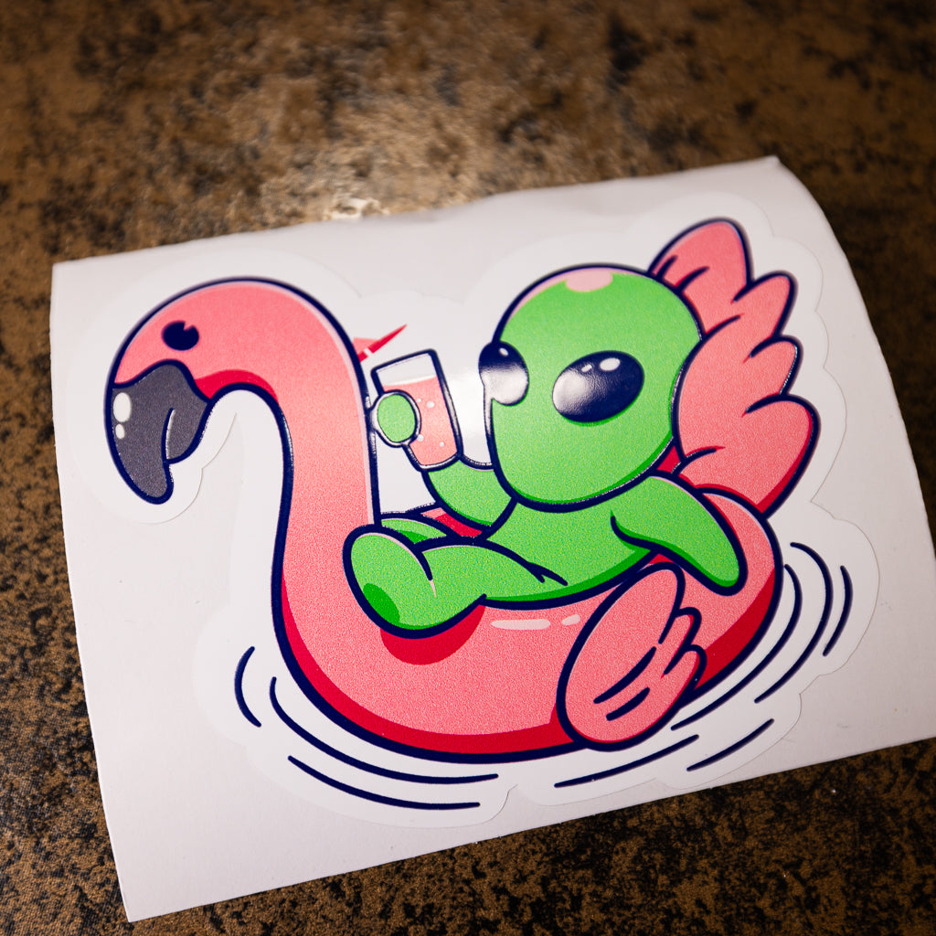 Custom embossed sticker of an alien in a inflatable flamingo